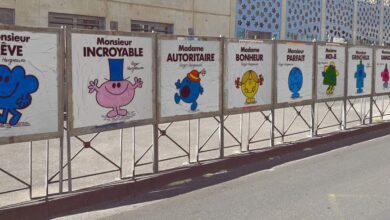 Une rangée d'affiches sur une palissade métallique à Châteaubriant met en scène des personnages de dessins animés colorés avec des titres français : Monsieur Rêve, Madame Parfait... Cette charmante exposition capture le charme de la créativité de la Loire-Atlantique, qui brille de mille feux comme un reportage d'Actu44.fr.